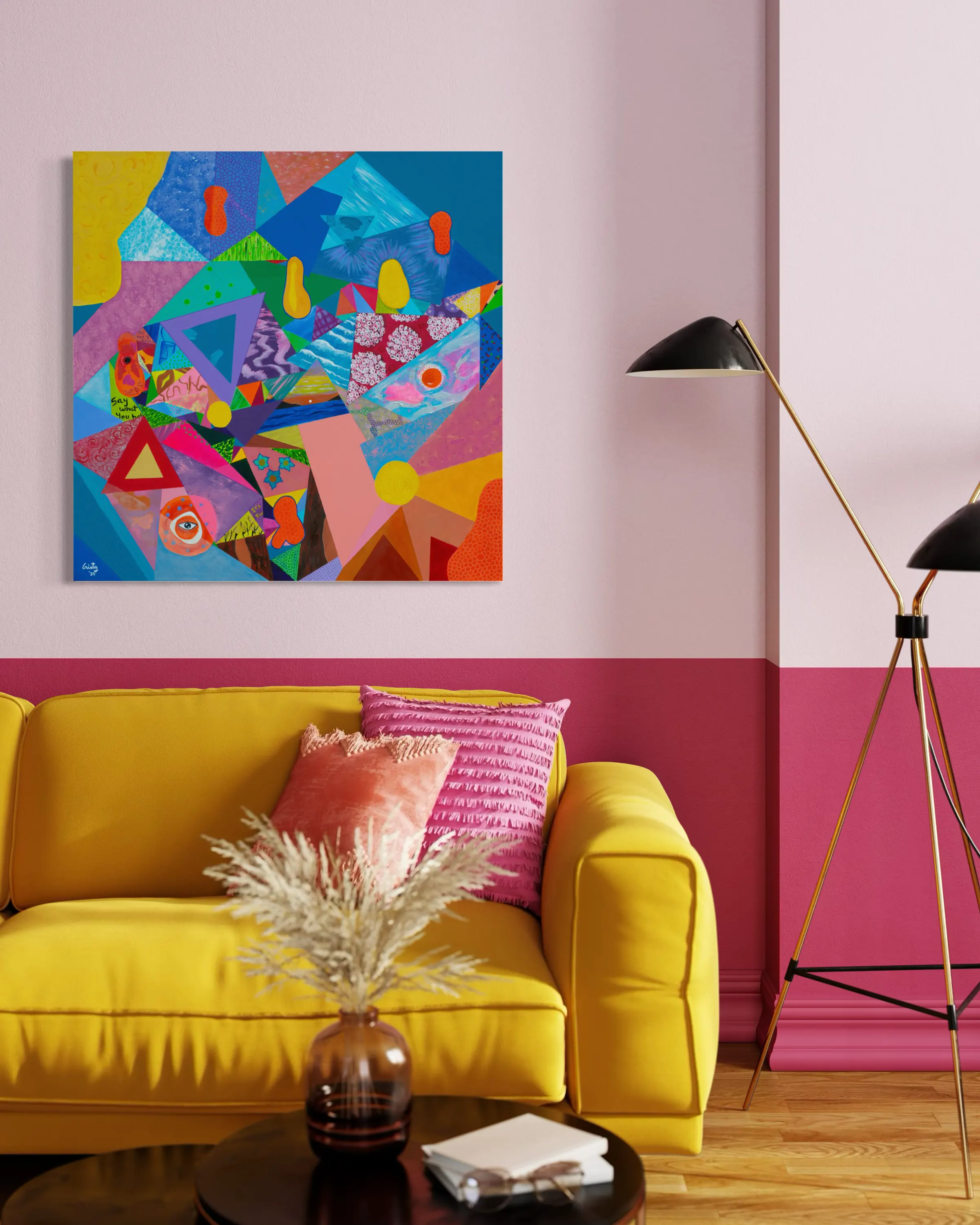 Thoughts hanging above a mustard-yellow sofa in a rose-pink living room.